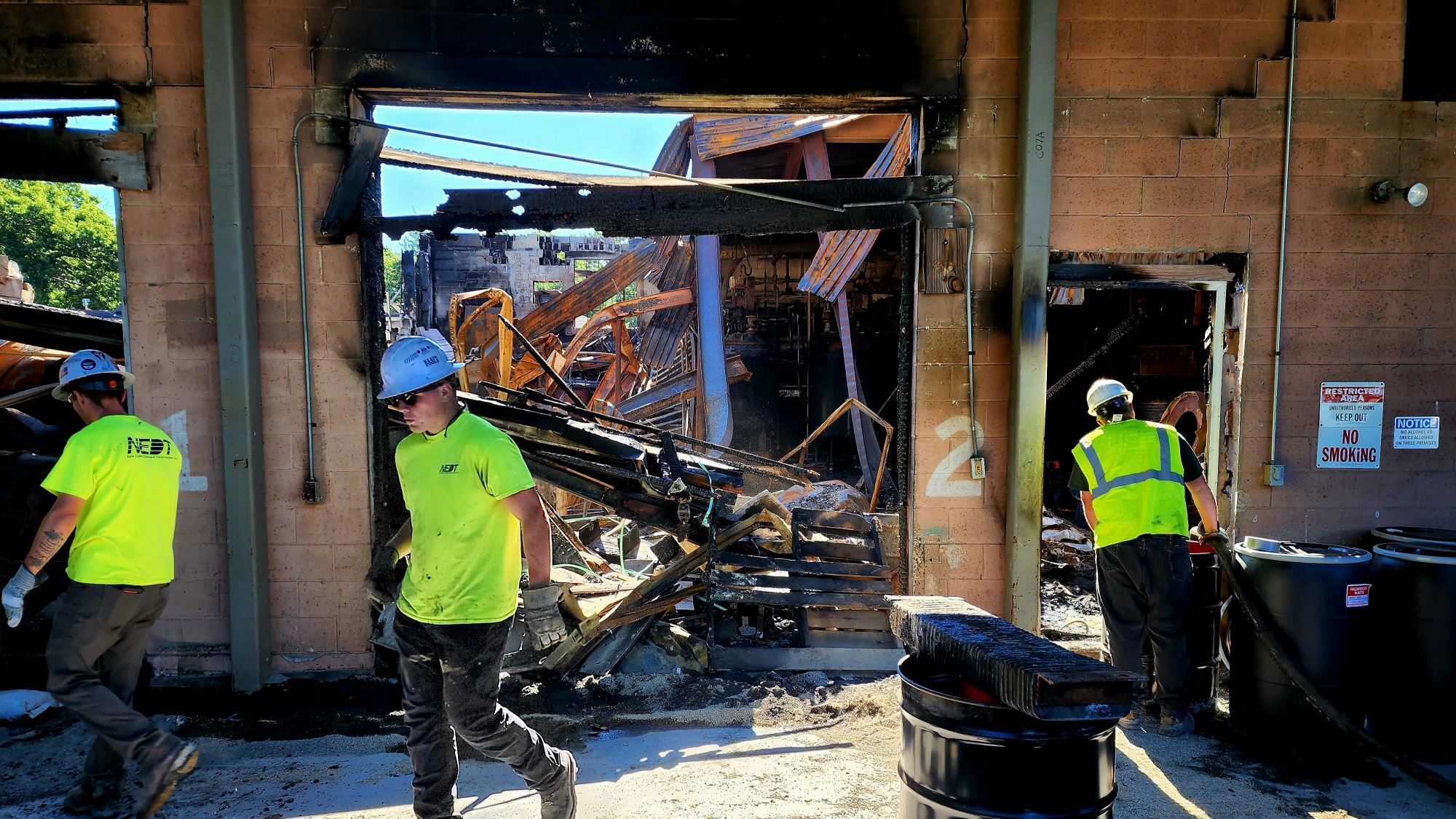 NEDT staff cleaning up a building damaged by fire.