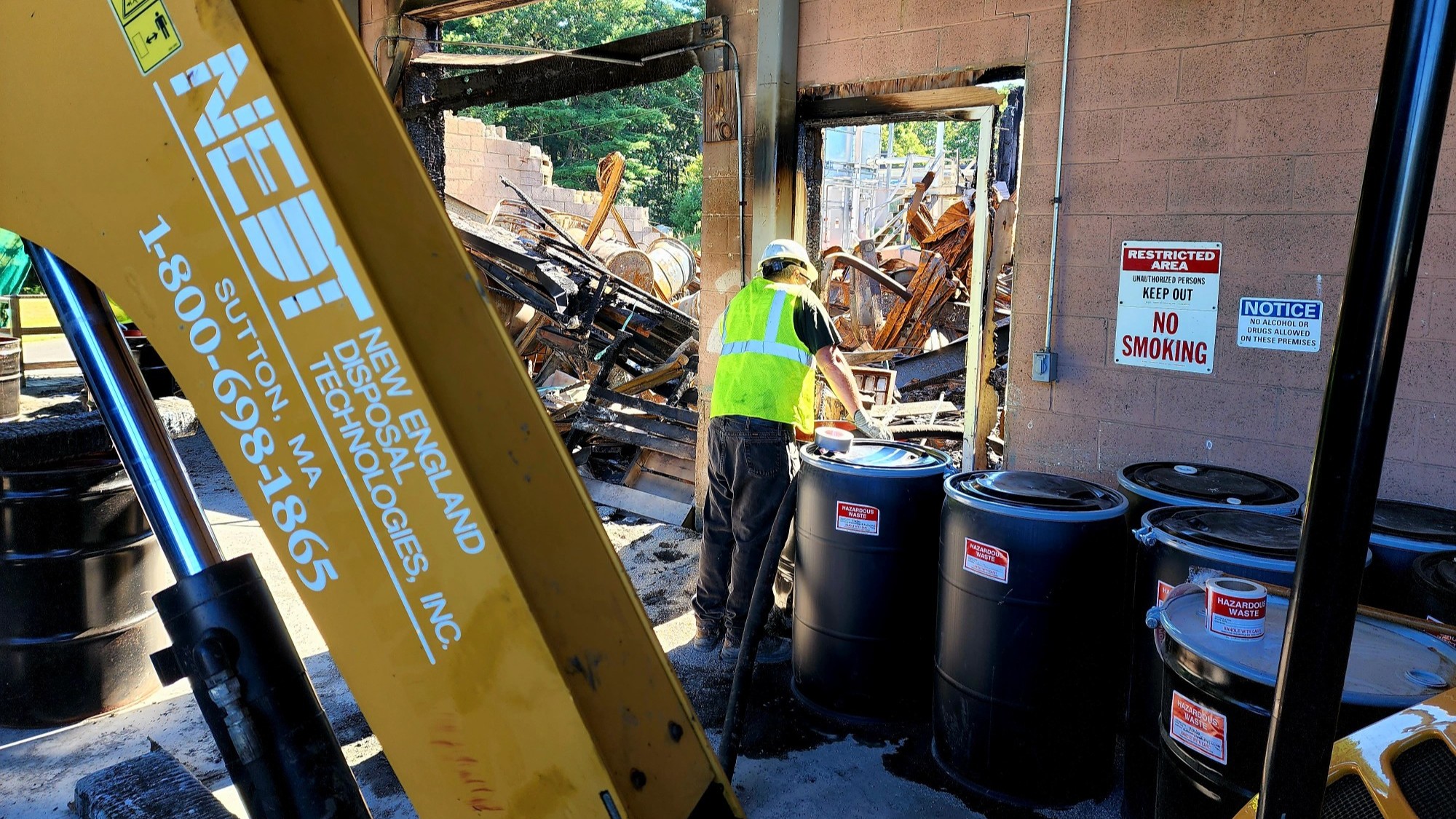 NEDT workers and equipment at the site of an industrial fire.