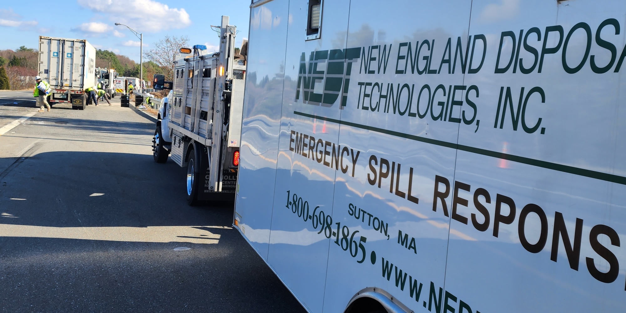 NEDT Emergency Spill Response vehicles performing roadside oil clean-up.