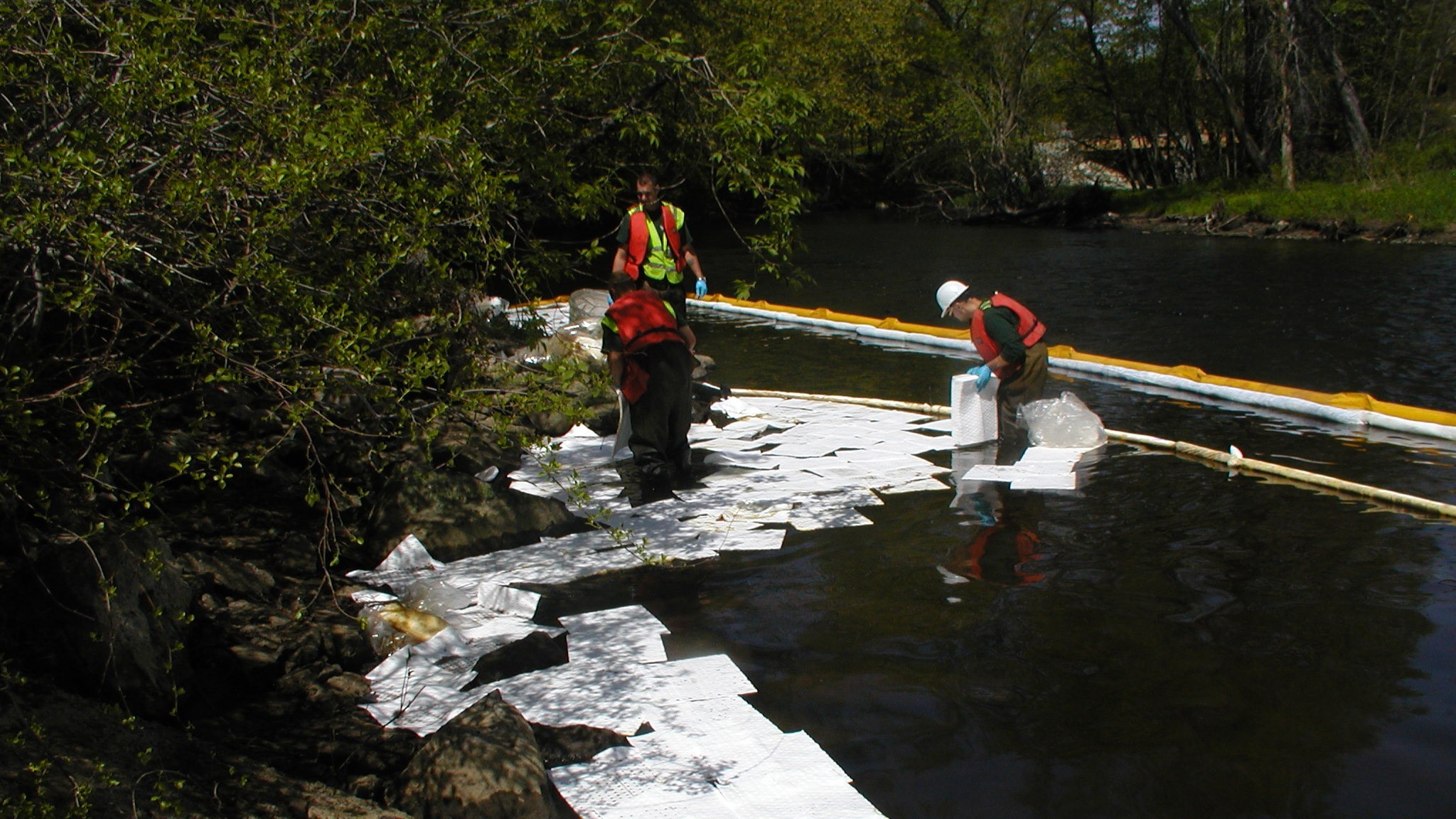 NEDT engineers deploy boon and remediation tools to clean up contaminated water.